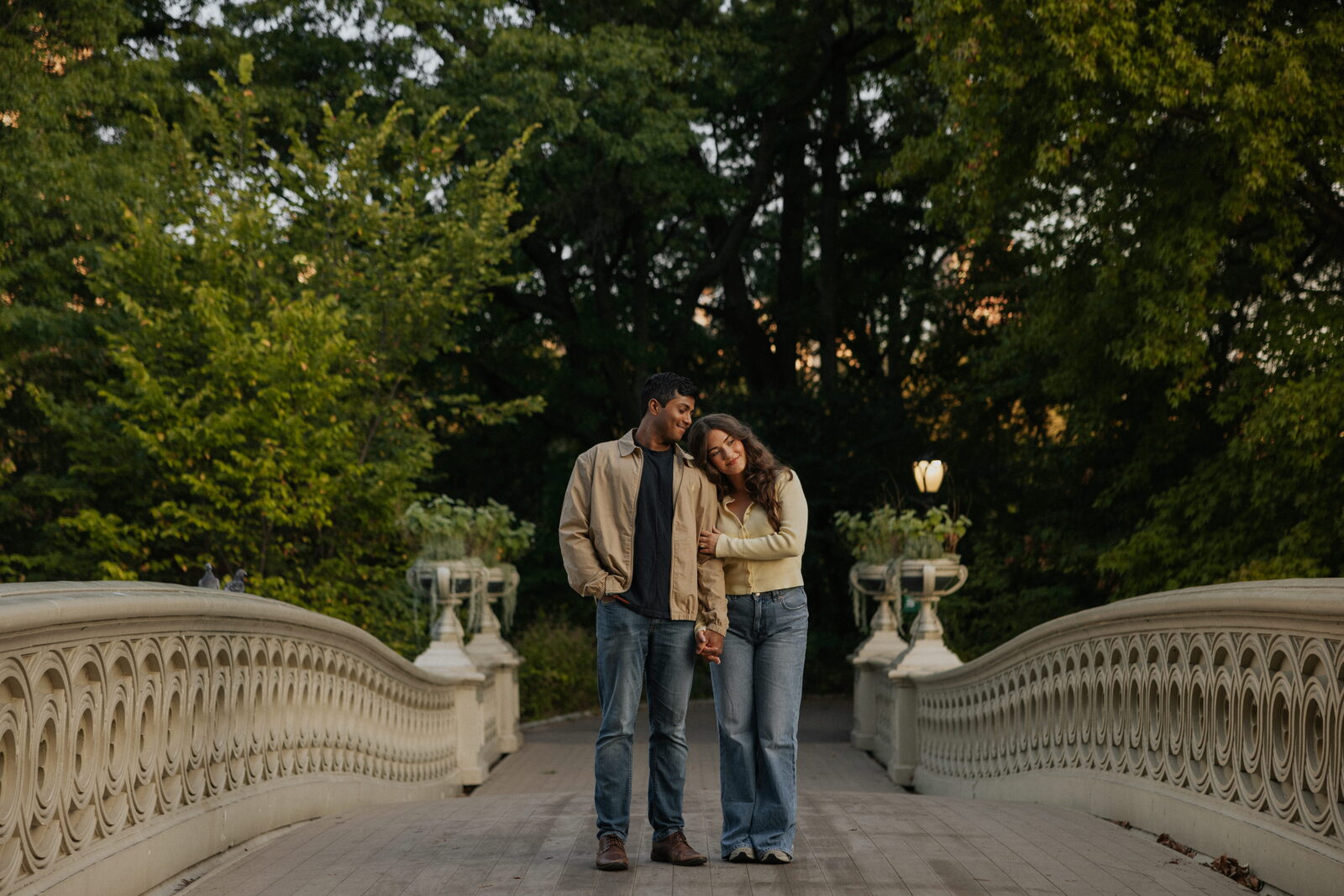Sai and his wife on a bridge at sunset
